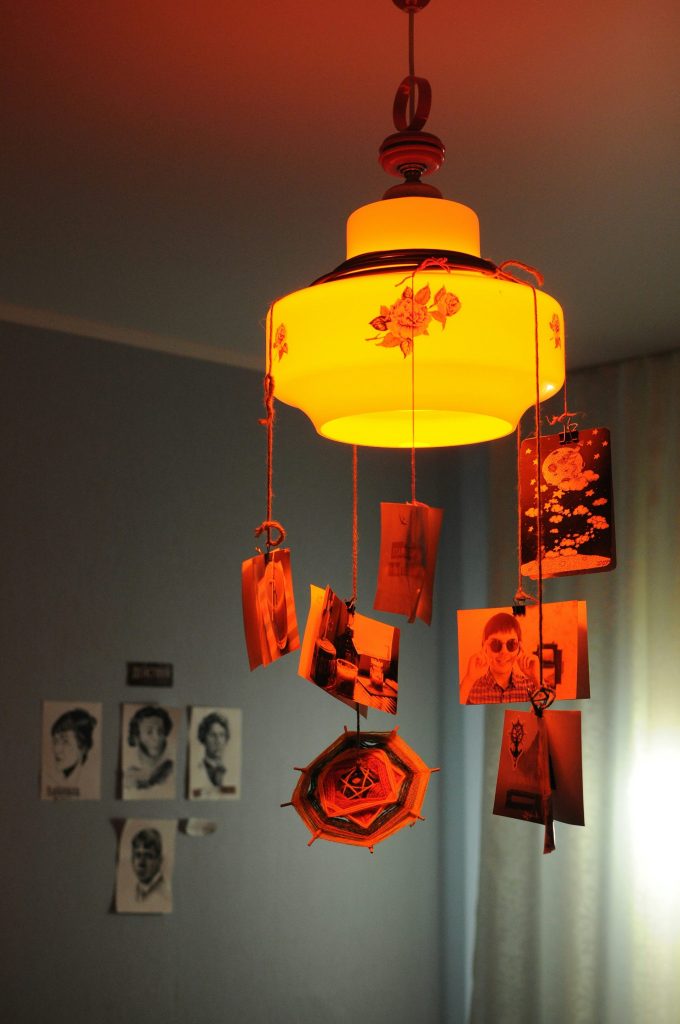 turned-on pendant lamp with hanging photos